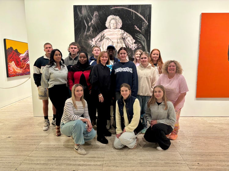 Photograph of students inside the Art Gallery of NSW in front of 2025 Archibald Prize winner Julie Fragar and artist Justene Williams