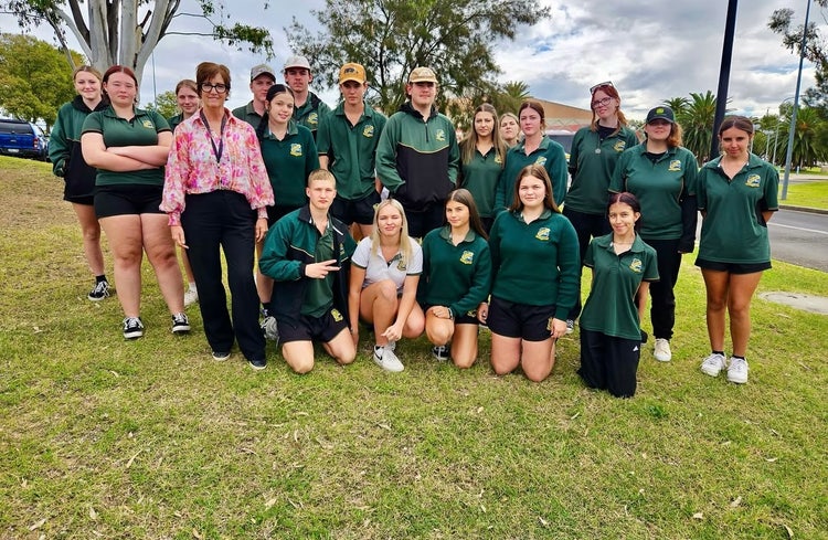 Photograph of students smiling wearing Wee Waa High School uniform standing on grassed area at careers expo