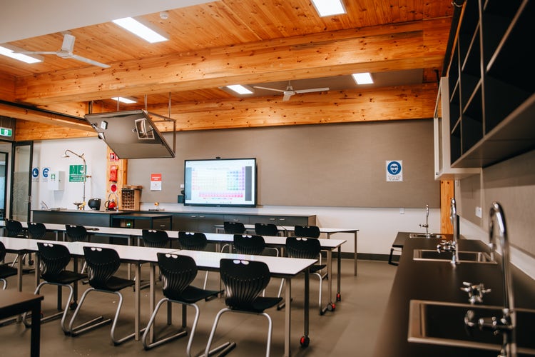 Photograph of interior of Wee Waa High School science lab with desks, chairs, high timber ceilings and experiment bench spaces