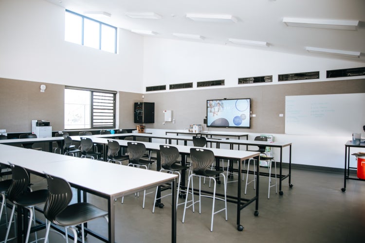 Photograph of Wee Waa High School agriculture room with desks, chairs, high half vaulted ceiling, and natural light