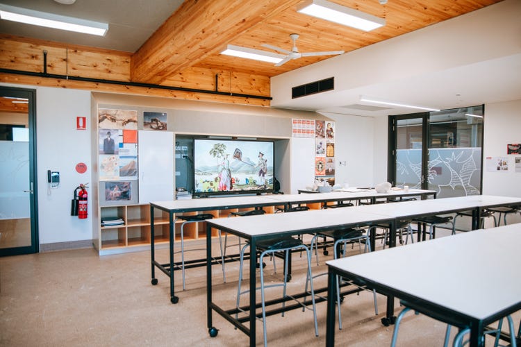Photograph of interior of Wee Waa High School art room with student art on walls, high timber ceilings, and natural light