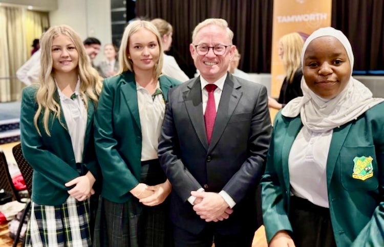 Photograph of students dressed in Wee Waa High School uniform with male dressed in black suit at public speaking event